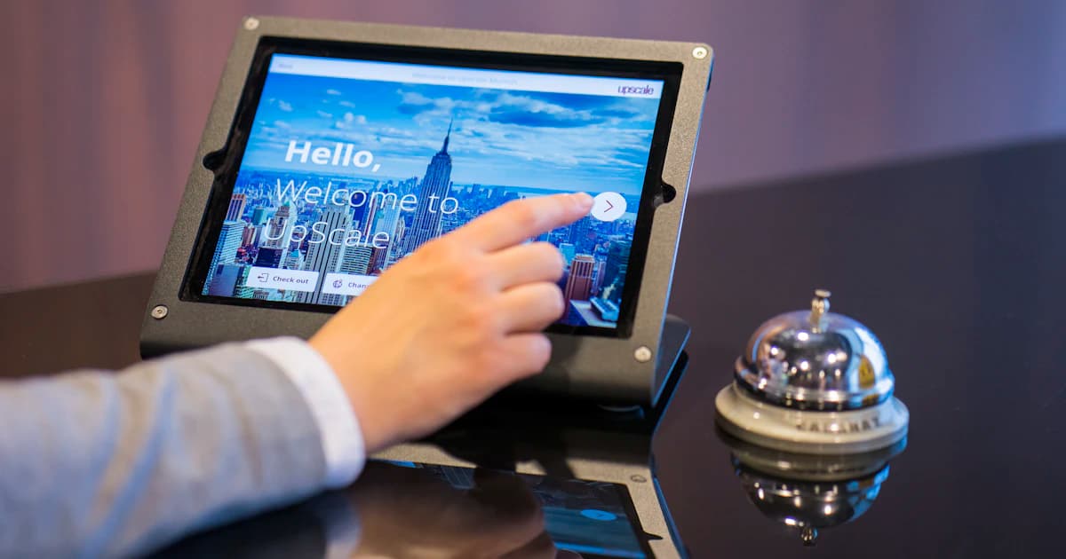 Hotel guest completing a satisfaction survey on a tablet at checkout