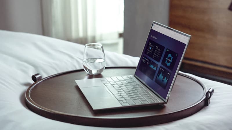Hotel manager reviewing guest feedback scores on a laptop